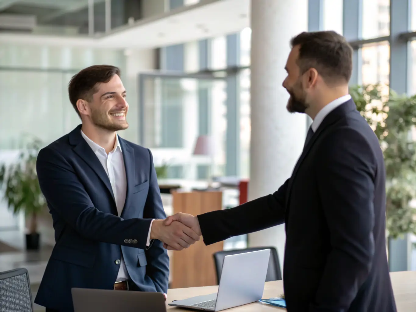 An image of a successful UK business owner shaking hands with their VanguardBrit coach, representing the positive impact of coaching on business growth.